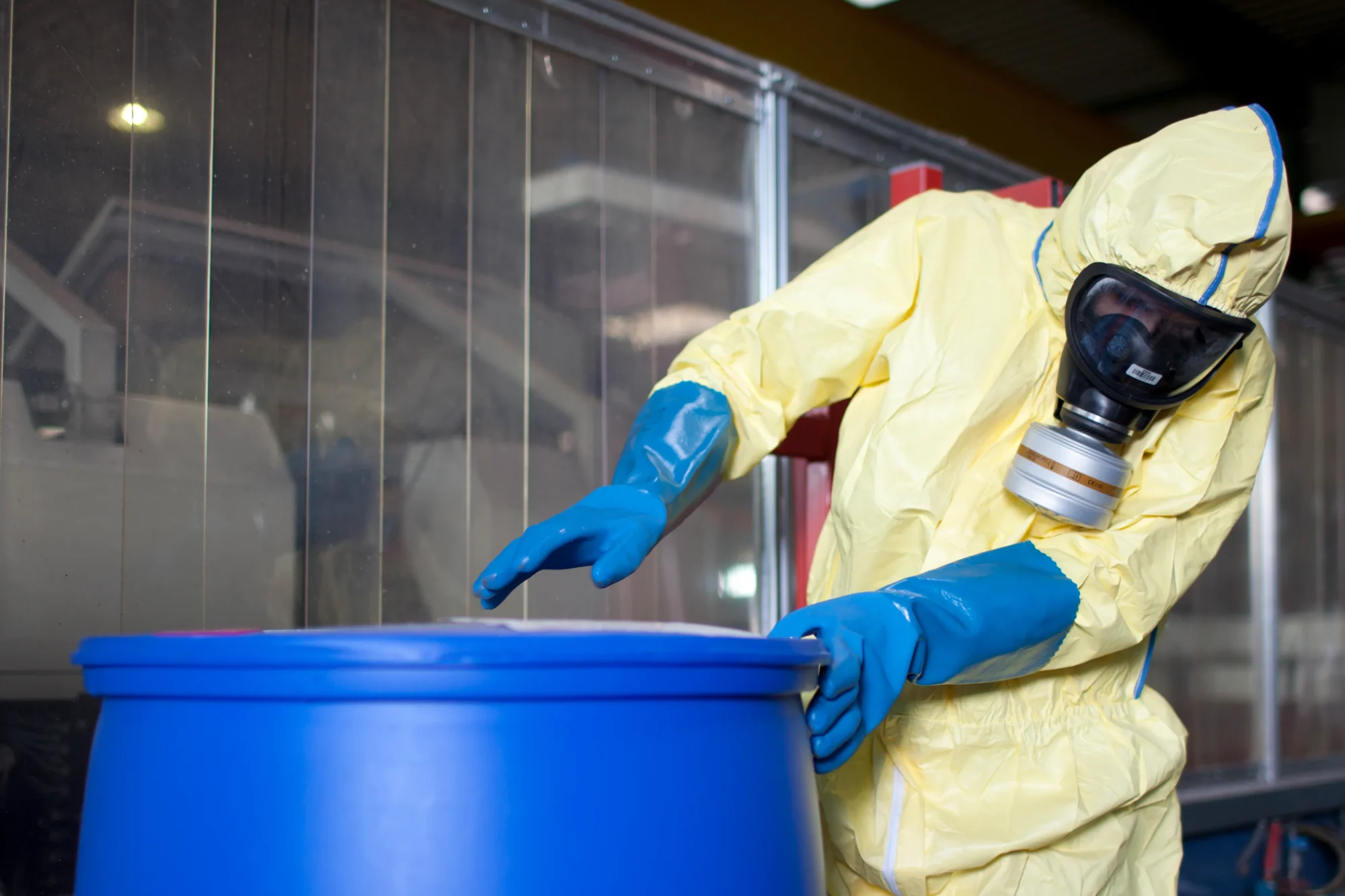 Worker handling hazardous waste container